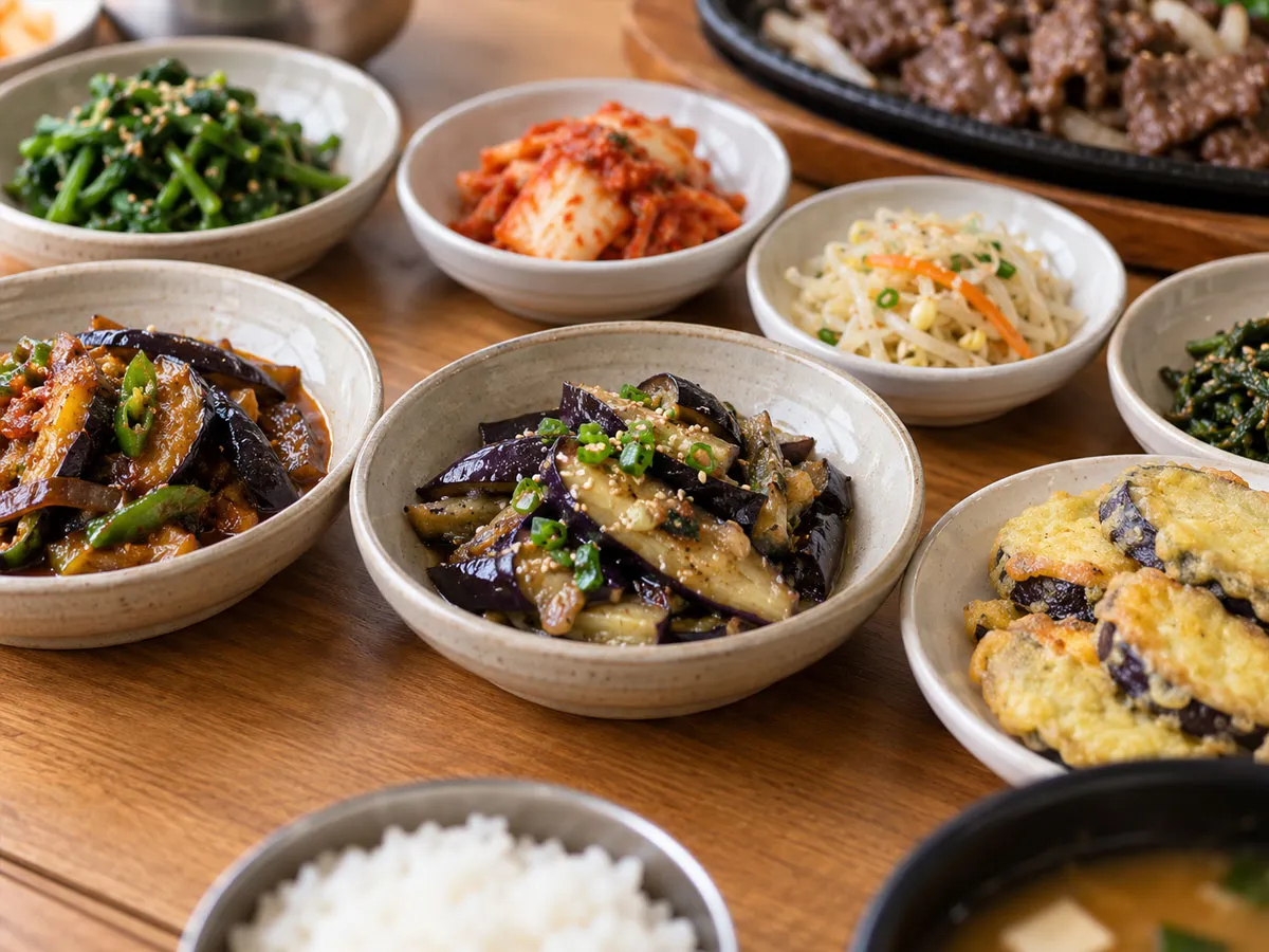 무침·볶음·부침 등 서로 다른 방식으로 조리된 가지 반찬을 한 상에서 보여주는 사진.