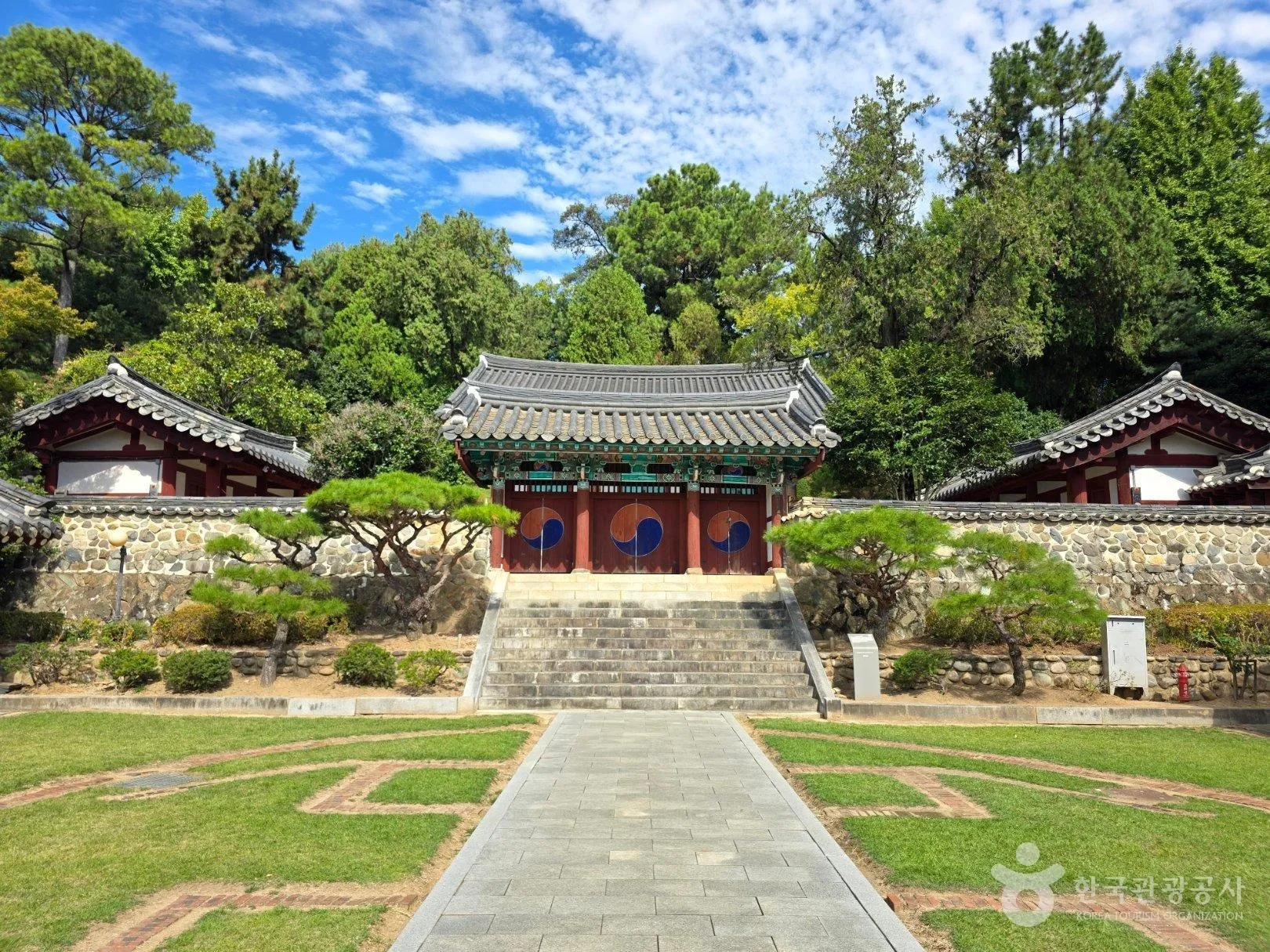 푸른 잔디 마당 너머 돌계단과 태극 문양이 그려진 내삼문.<br>한국관광공사 홈페이지